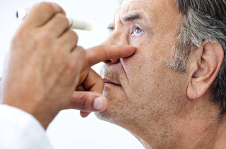 Un homme âgé se fait examiner par un optometrist