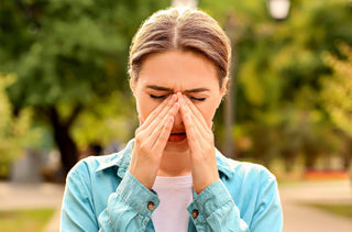 Une femme est sur le point d'éternuer à cause de ses allergies