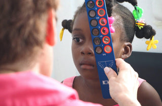 Une jeune fille haïtienne passe un examen de la vue