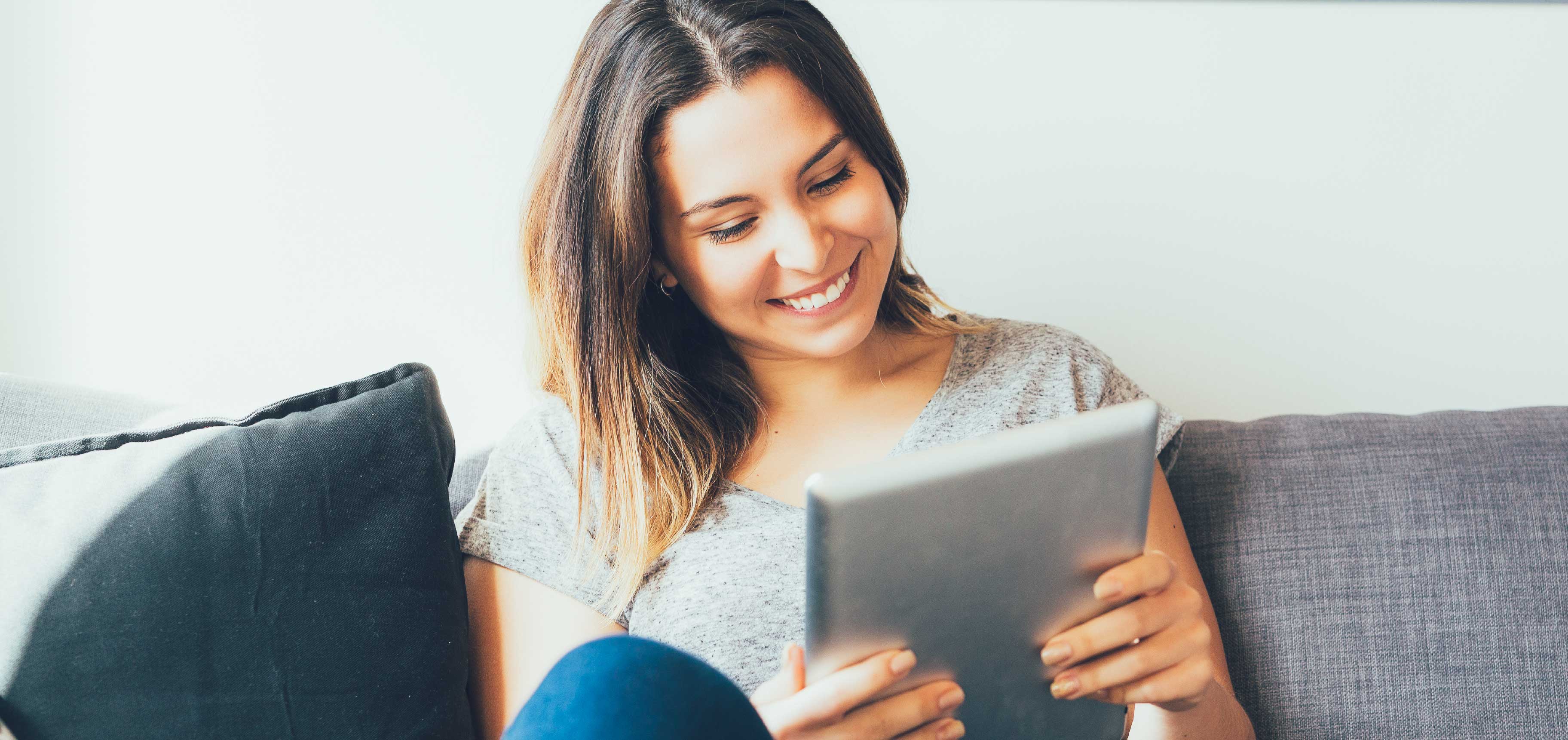 A lady is looking at her tablet