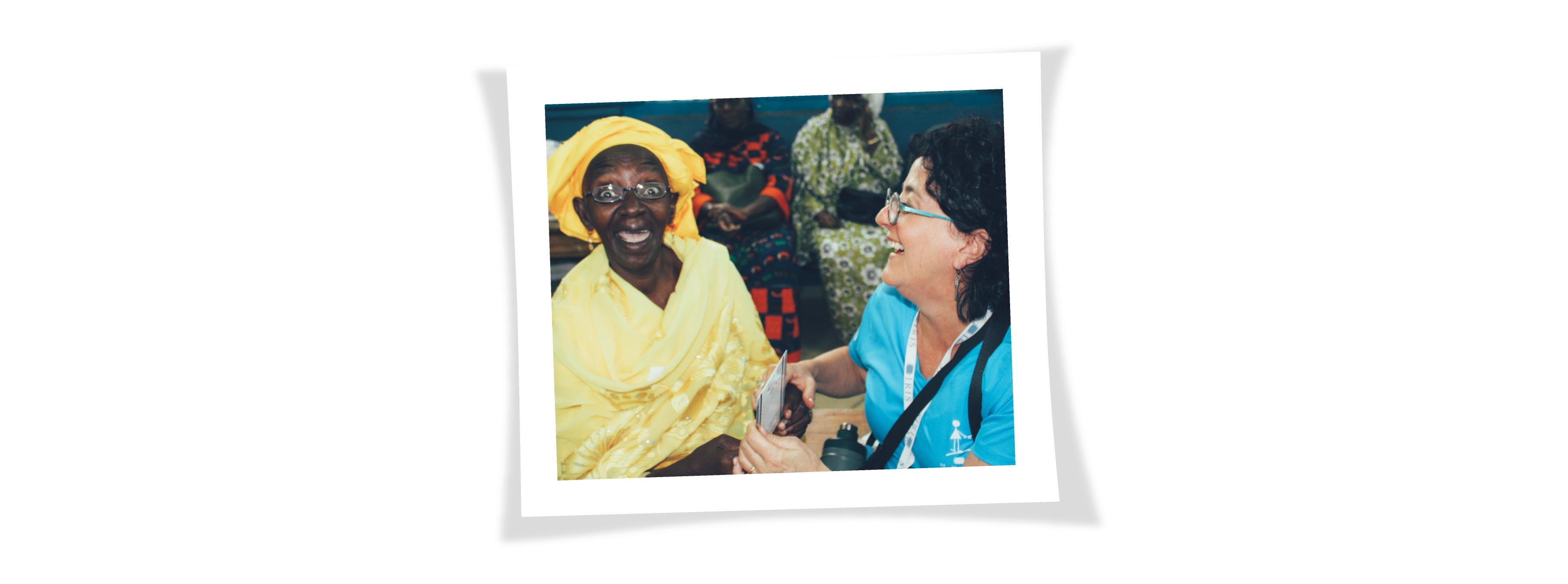 A patient is freaking out when she sees through her glasses for the first time and the IRIS Mundial volunteer explodes in laughter when she sees her