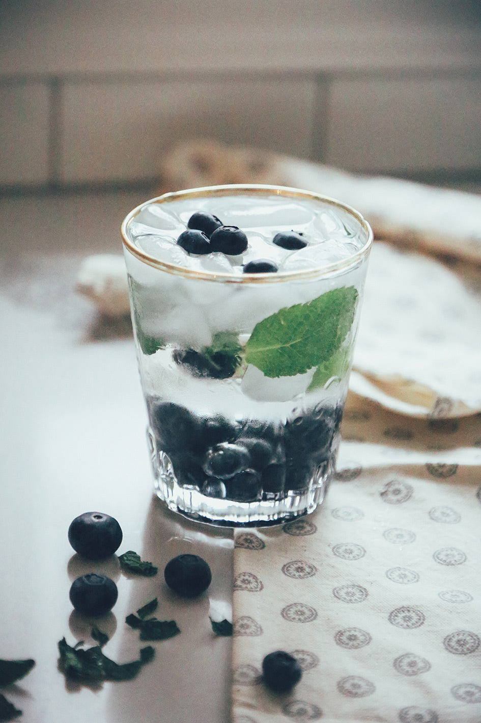 Glass of water with mint and blueberries