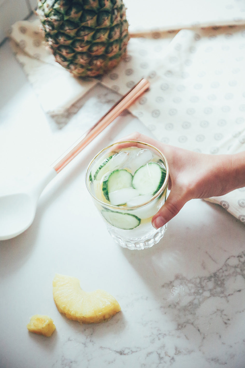 Glass of water with pineapple and cucumber