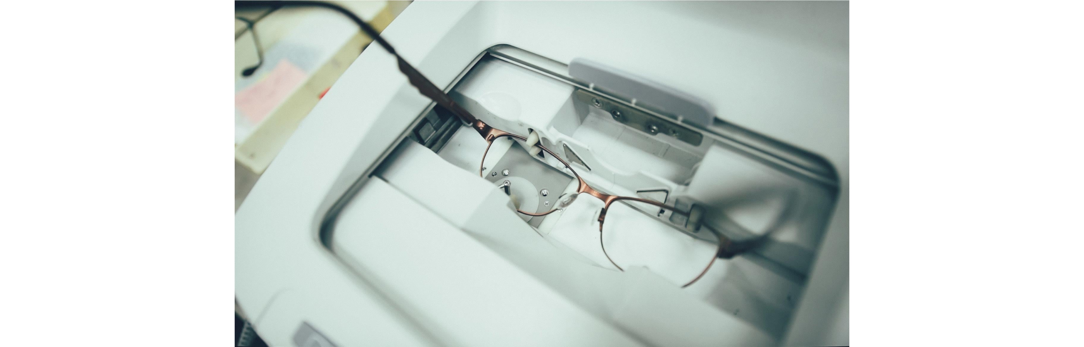 The lenses of glasses are being analyzed by a robot